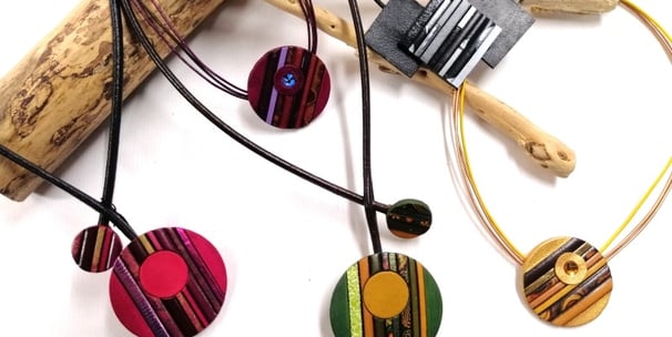 a bunch of necklaces with different colored circles