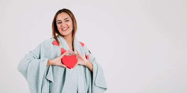 mulher segurando um coração feliz com a sua saúde