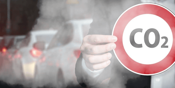 a man in a suit holding a sign that says co2