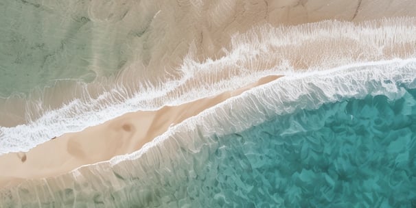a person standing on a beach with a surfboard