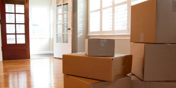 an empty room with moving boxes