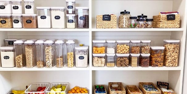 an organized pantry with a variety of bins and containers so everything is sorted