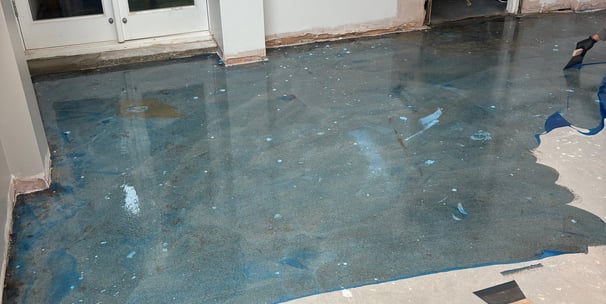 A concrete floor with blue primer