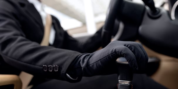 Driver is driving in black gloves