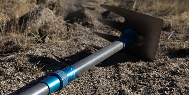 a shoveled shovel with a metal handle and a blue handle