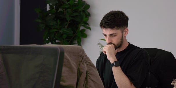 a man sitting at a desk with a laptop computer