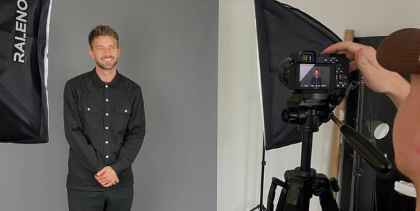 a man in a black shirt and a camera