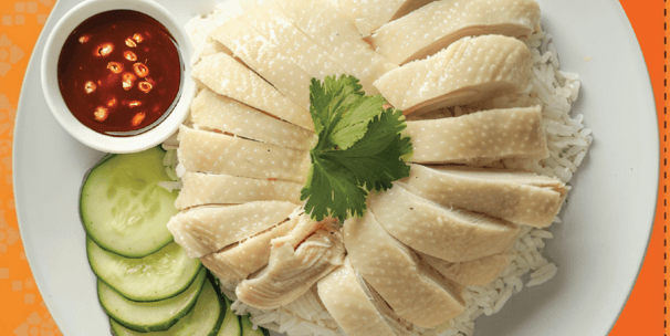 a plate of rice with a sauce and cucumber