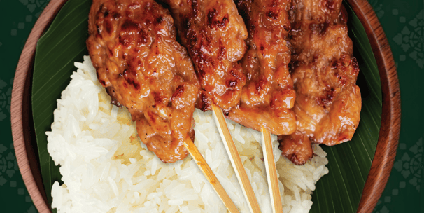 a bowl of food with chopsticks and chopsticks