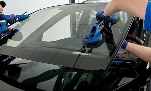 a man cleaning a car with a vacuum