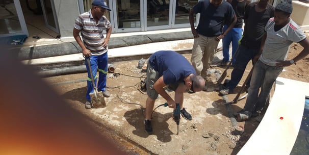 Slowly drilling of the slab to release trapped water for advanced waterproofing project, Sandton, Fredman Drive