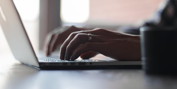 a person typing on a laptop computer