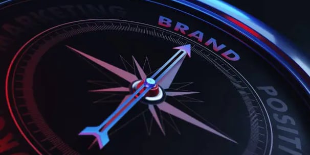 a compass - shaped compass with the word brand on it