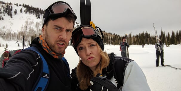 couple making silly faces snow skiing