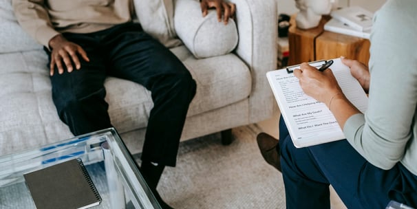 Person sitting down on a couch on therapy