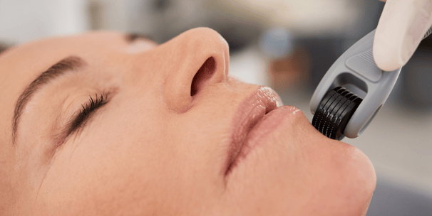 a woman is getting her teeth brushed with a brush