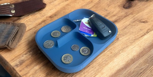 a tray with coins and wallets on a table