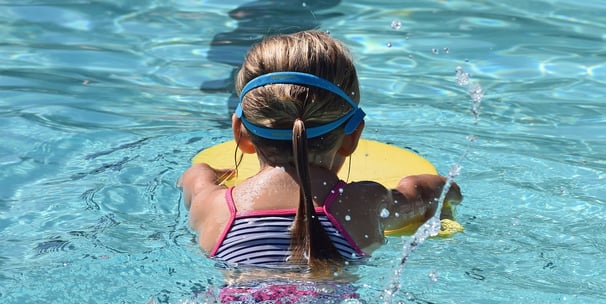 young child learning to swim