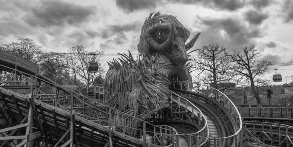 wooden roler coaster track with thr rear of the wicker man and some sky ride gondolas 