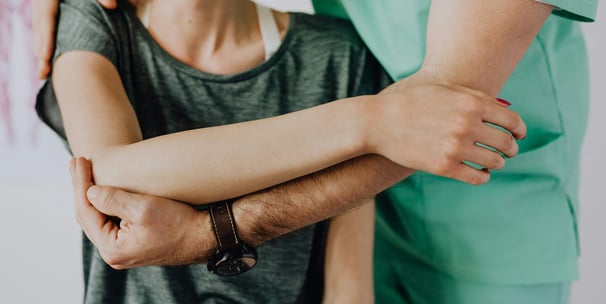 a therapist adjusting a woman's body