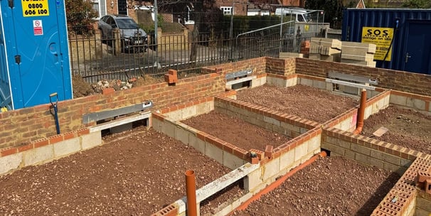 Groundwork contractor installing drainage system
