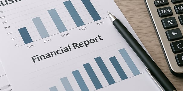 Financial records and projections for small business bookkeeping services sheet, pen and calculator