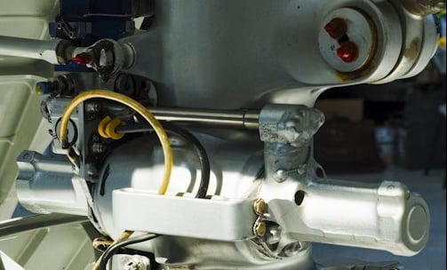 Close-up view of a metal mechanical component, likely part of an aircraft's landing gear assembly.