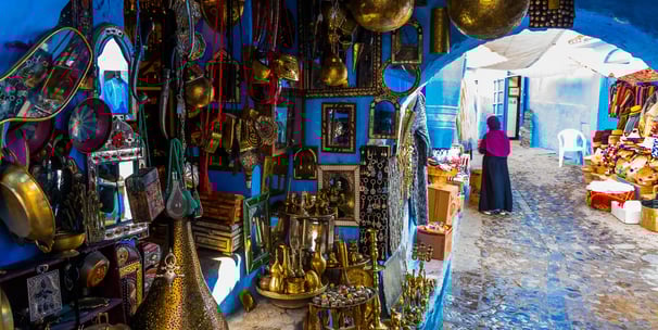 a woman in a blue room with a lot of gold