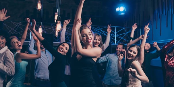 Large private group dancing and celebrating during a custom nightlife crawl on Fremont Street in Downtown Las Vegas