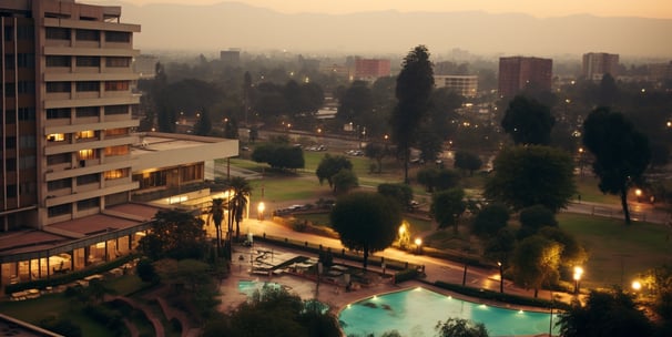 a view of a pool and the cityscape from a hotel