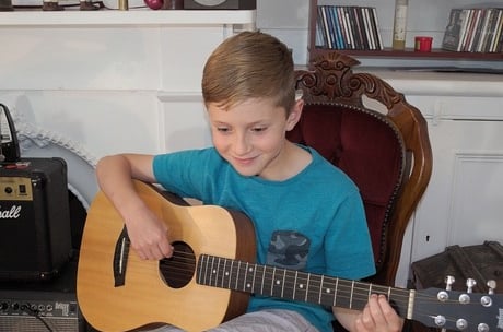 A boy playing guitar