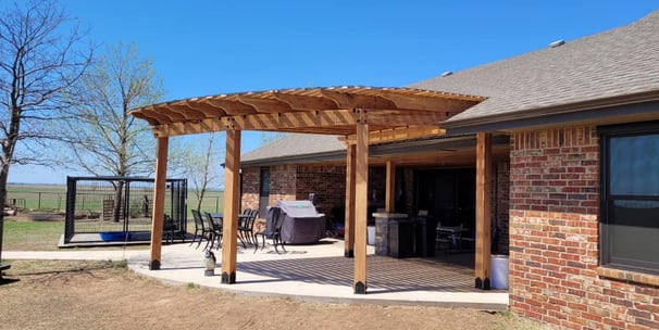 a back patio with a pure cedar pergola roof