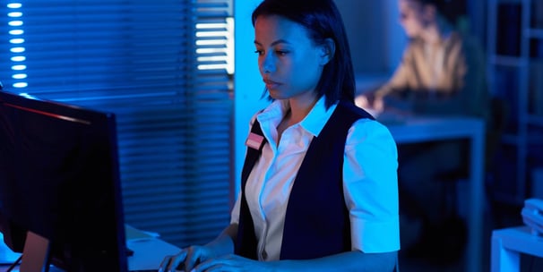 Side view portrait of young woman watching surveillance camera