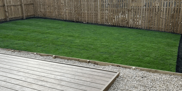 Freshly laid turf and garden edging with raised beds in Bristol