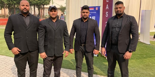 a group of men in suits standing in front of a building