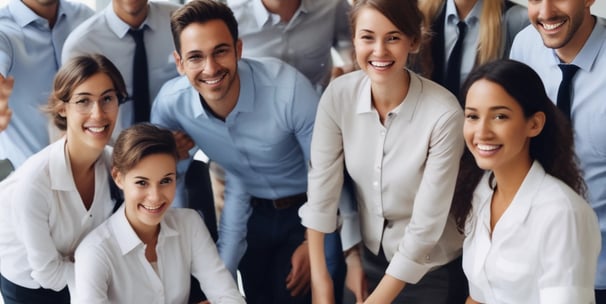 A group of people dressed in formal attire are standing in front of a real estate office. The storefront displays a large sign with an URL and various social media icons, and text in a foreign language. The group mostly consists of men in white shirts and dark trousers, standing in a straight line, with two women at either end of the row.