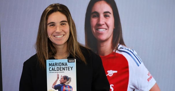 a woman holding a book about a woman's life