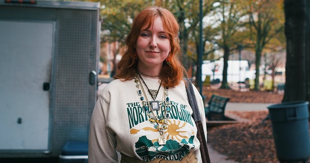 Young redheaded college woman smiling at camera.
