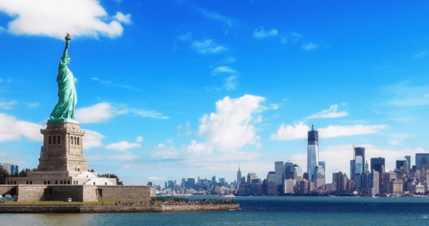 a statue of liberty in front of NYC skyline