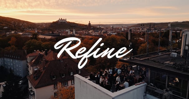 a rooftop with a view of a city skyline and the sun setting in the back