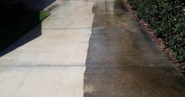 a drive way one half of it has been pressure washed the other is still dirty comparison photo