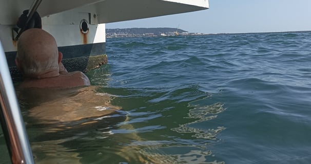 B. cleaning weed from the propellor.