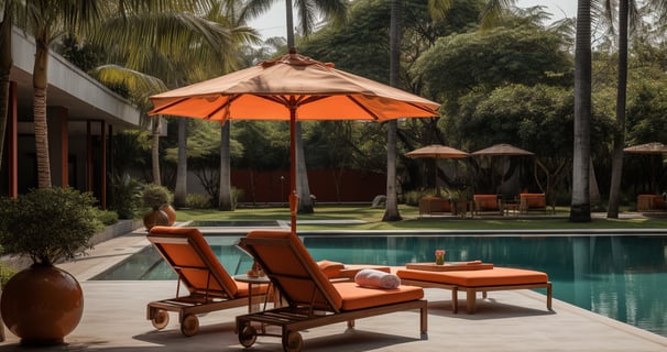 a lounge chair with an umbrella and a table with a cup of coffee