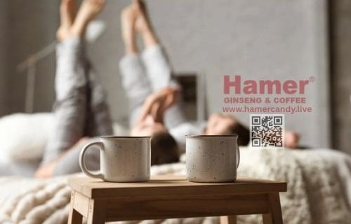two cups of coffee and a woman in a bed hamer candy