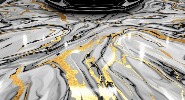 Gold, black, and white metallic epoxy coating in a garage with a corvette