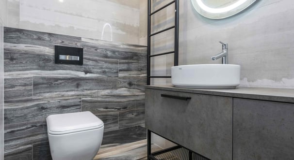 Modern grey-tiled bathroom with floating vanity