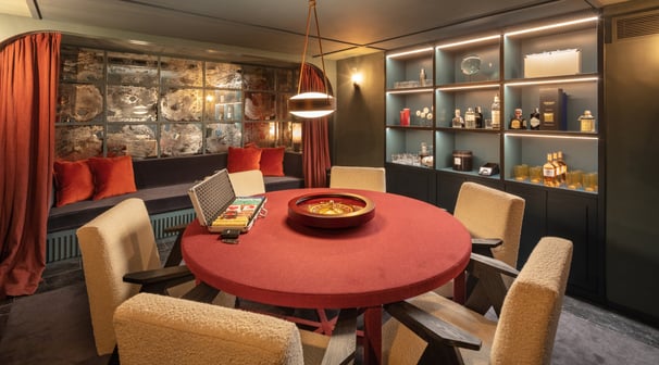 Cigar and poker room at Villa La Gratitud, with roulette table, whiskey bar, and lounge seating.