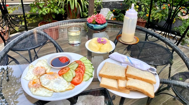 a table with a plate of food and a drink