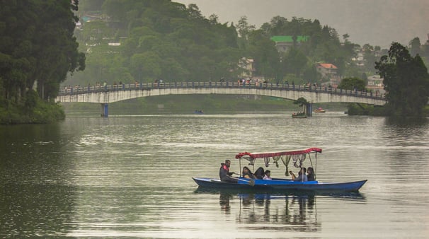 tourist boating in Sumendu lake while enjoying the view of Indreni Pool