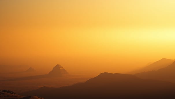 UniverseX - a person standing on a mountain top with a view of the sun setting